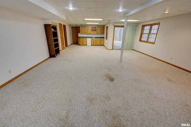591 Breezy Point Dr, Clinton, IA 52732 - basement with baseboards, light carpet, wet bar, and a drop ceiling