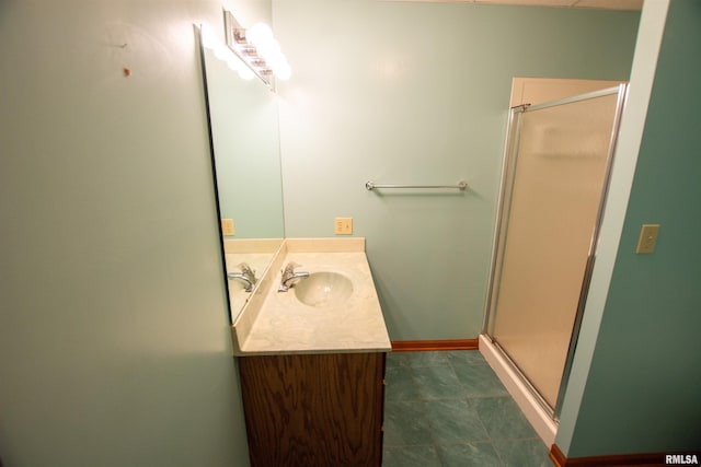 591 Breezy Point Dr, Clinton, IA 52732 - bathroom featuring vanity, a shower stall, and baseboards