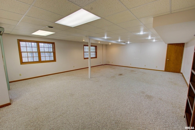 591 Breezy Point Dr, Clinton, IA 52732 - below grade area featuring a drop ceiling, carpet, and baseboards
