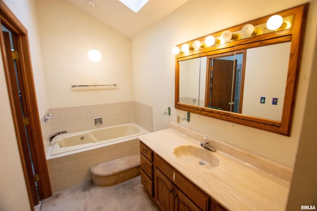 591 Breezy Point Dr, Clinton, IA 52732 - bathroom with a skylight, vaulted ceiling, vanity, and a bath