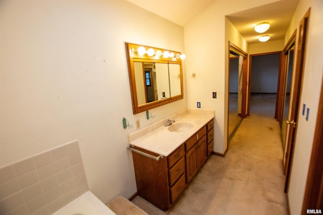 591 Breezy Point Dr, Clinton, IA 52732 - full bath with vanity, vaulted ceiling, and a tub to relax in