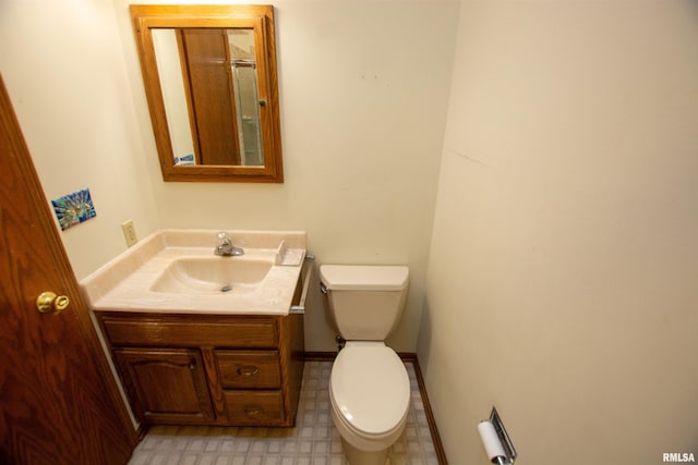 591 Breezy Point Dr, Clinton, IA 52732 - half bathroom featuring toilet, vanity, and tile patterned floors