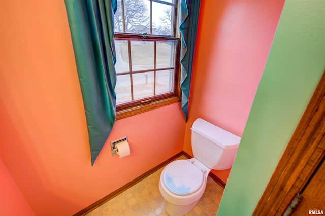 591 Breezy Point Dr, Clinton, IA 52732 - bathroom with toilet, tile patterned floors, and baseboards