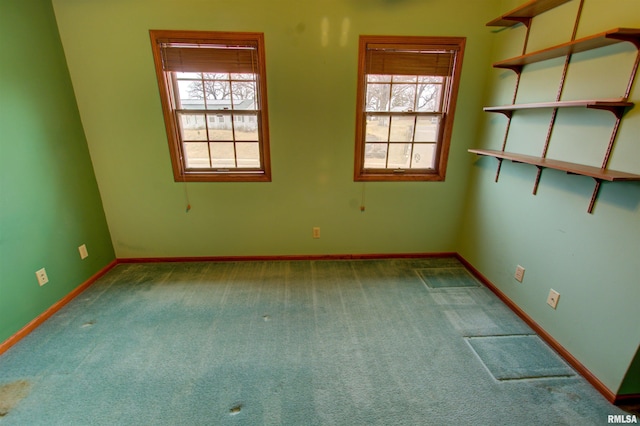 591 Breezy Point Dr, Clinton, IA 52732 - carpeted empty room with plenty of natural light and baseboards