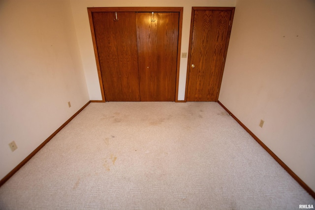591 Breezy Point Dr, Clinton, IA 52732 - unfurnished bedroom with light carpet and baseboards