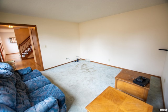 591 Breezy Point Dr, Clinton, IA 52732 - living area featuring stairway, baseboards, and carpet floors