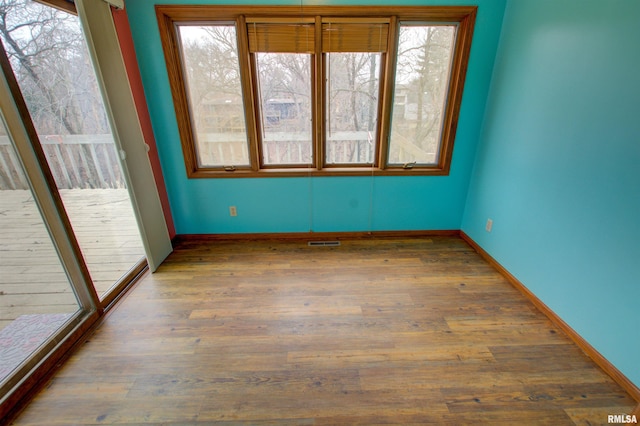 591 Breezy Point Dr, Clinton, IA 52732 - spare room with plenty of natural light, wood finished floors, and baseboards