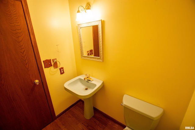 591 Breezy Point Dr, Clinton, IA 52732 - half bath with wood finished floors, toilet, and baseboards