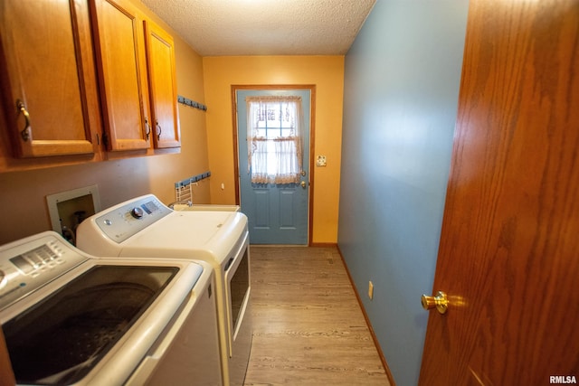 591 Breezy Point Dr, Clinton, IA 52732 - laundry room with cabinet space, independent washer and dryer, light wood finished floors, a textured ceiling, and baseboards