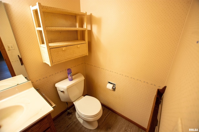 591 Breezy Point Dr, Clinton, IA 52732 - half bathroom with wood finished floors, toilet, and vanity