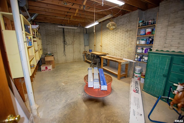 591 Breezy Point Dr, Clinton, IA 52732 - unfinished basement with electric panel, brick wall, and a workshop area