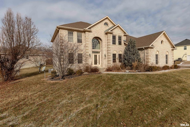 view of front of house featuring a front lawn and central AC unit