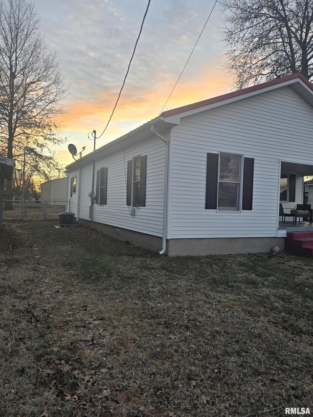 back house at dusk with covered porch