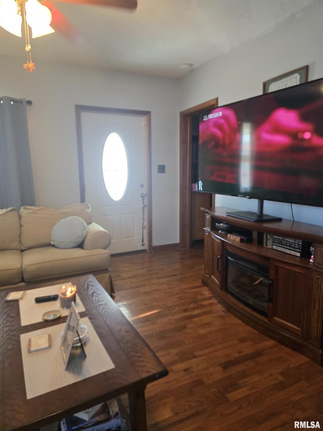 living room featuring dark hardwood / wood-style flooring and ceiling fan