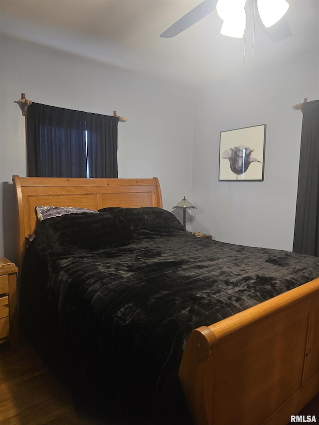 bedroom with dark wood-type flooring and ceiling fan