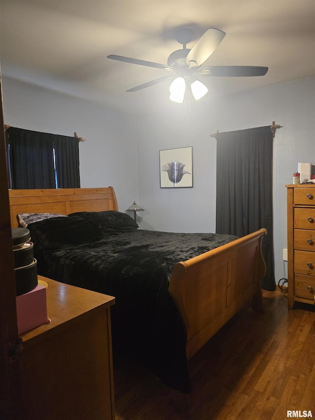 bedroom featuring ceiling fan and dark hardwood / wood-style flooring