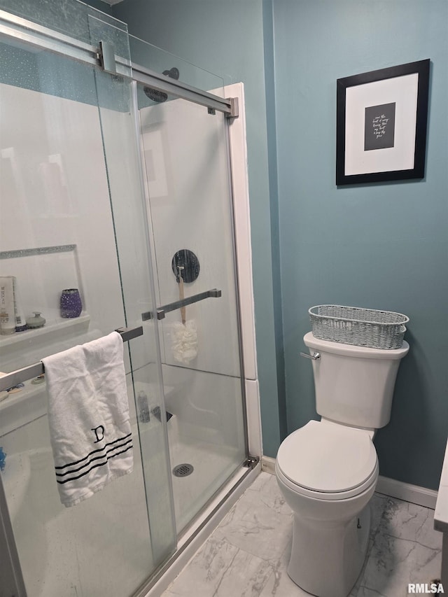 bathroom with toilet and an enclosed shower