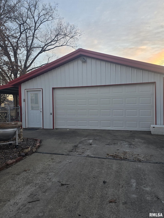 view of garage at dusk