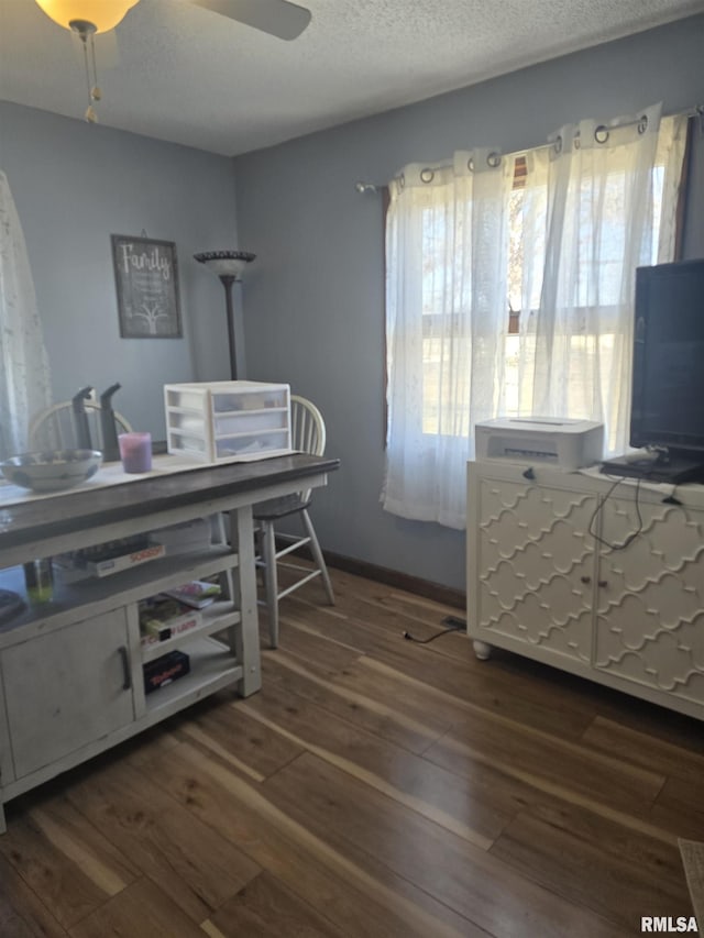 office space featuring ceiling fan, dark wood-type flooring, and a textured ceiling