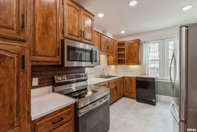 kitchen with sink, appliances with stainless steel finishes, and tasteful backsplash