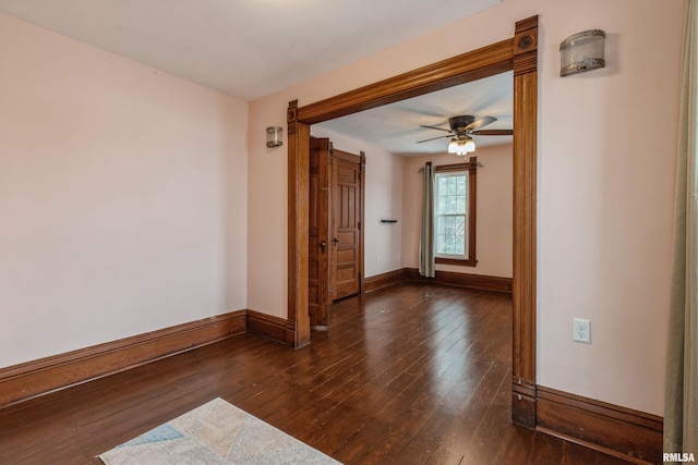 spare room featuring ceiling fan and dark hardwood / wood-style flooring