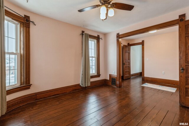 unfurnished room with ceiling fan and dark wood-type flooring