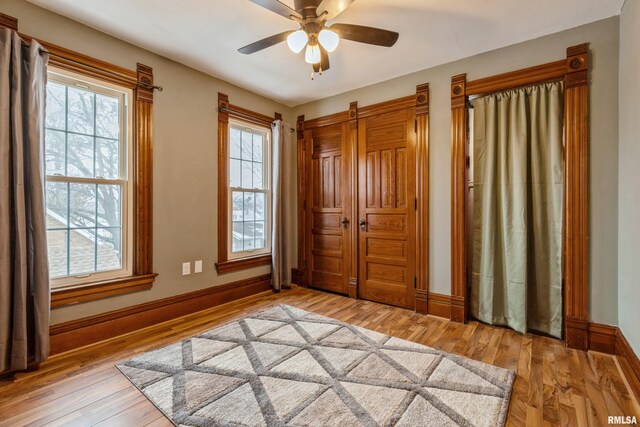 interior space featuring light wood-type flooring, ceiling fan, and a healthy amount of sunlight