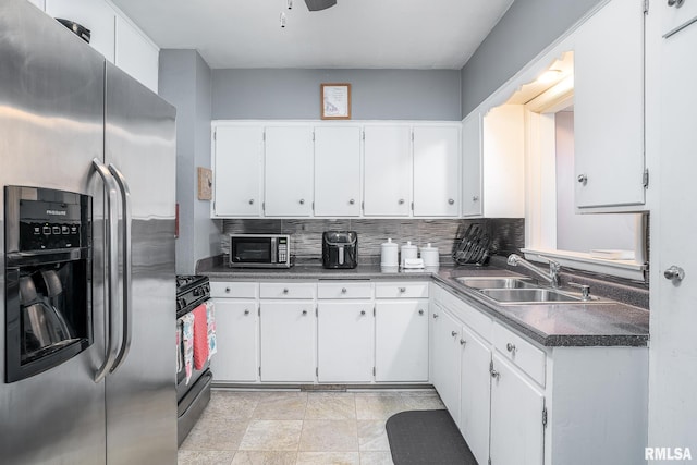 kitchen with sink, tasteful backsplash, white cabinetry, and appliances with stainless steel finishes