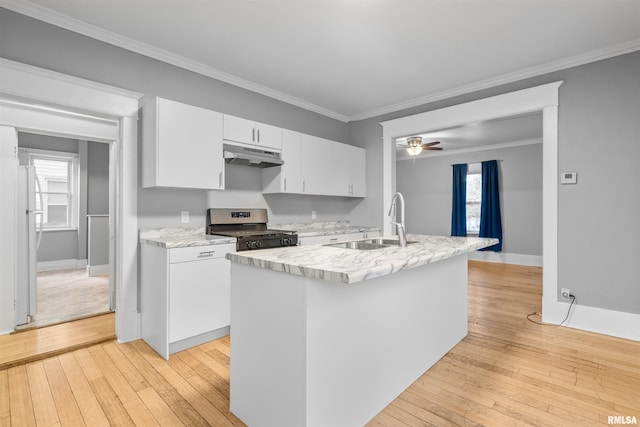 kitchen with white cabinetry, sink, white refrigerator, a center island with sink, and stainless steel gas range