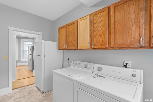 laundry area with cabinets and washing machine and clothes dryer