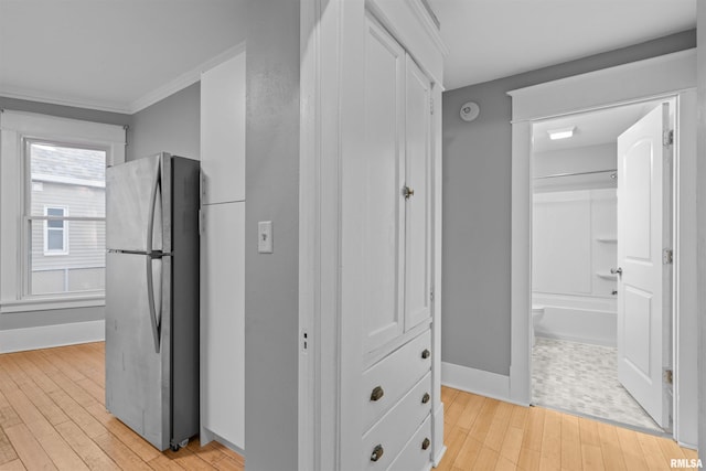 hallway featuring light hardwood / wood-style flooring and ornamental molding