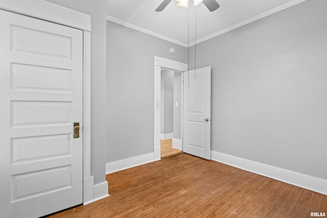 unfurnished bedroom featuring wood-type flooring, crown molding, and ceiling fan