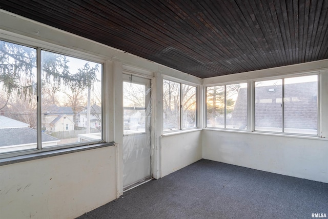 unfurnished sunroom with wood ceiling