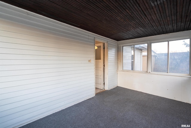 unfurnished sunroom featuring wood ceiling