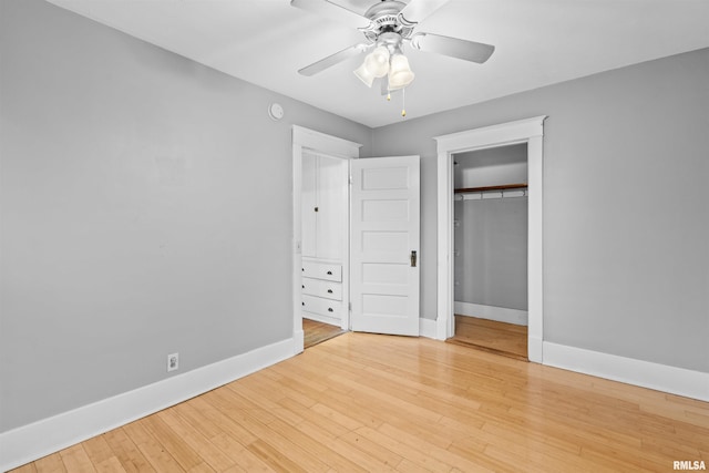 unfurnished bedroom with ceiling fan, a closet, and light wood-type flooring