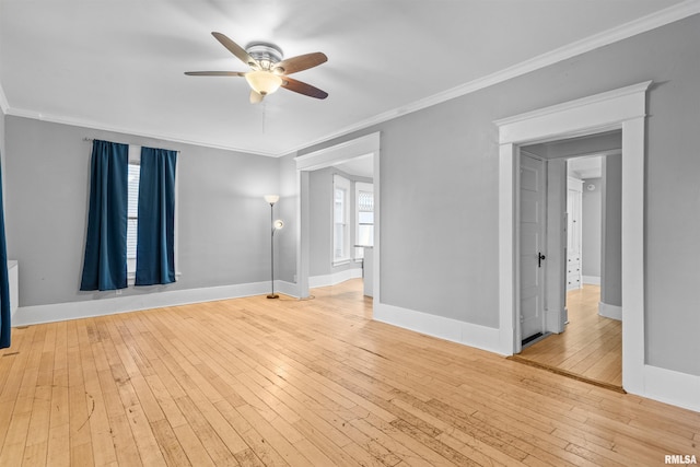 empty room with ornamental molding, ceiling fan, and light hardwood / wood-style flooring