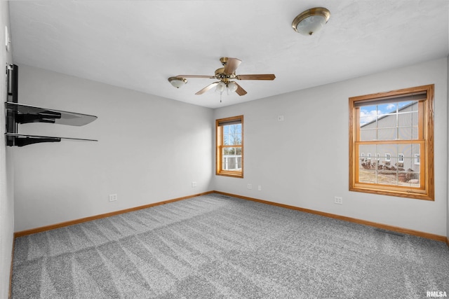 2260 260th Ave, De Witt, IA 52742 - empty room with baseboards, carpet floors, and ceiling fan