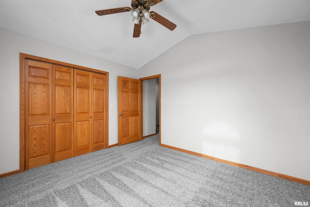 unfurnished bedroom with ceiling fan, carpet floors, vaulted ceiling, and a closet