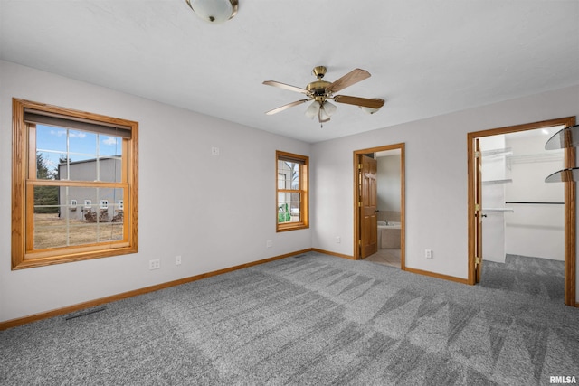 2260 260th Ave, De Witt, IA 52742 - unfurnished bedroom featuring baseboards, carpet floors, a walk in closet, and ensuite bathroom