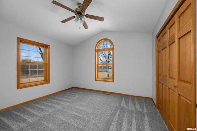 2260 260th Ave, De Witt, IA 52742 - unfurnished bedroom with lofted ceiling, baseboards, carpet floors, a closet, and a ceiling fan