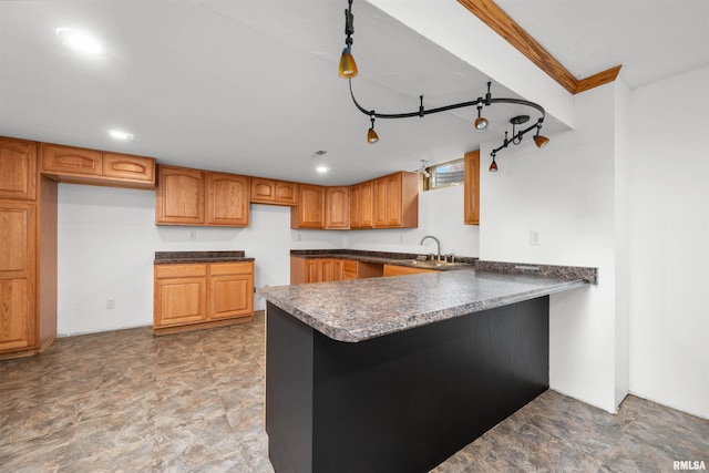 2260 260th Ave, De Witt, IA 52742 - kitchen featuring a sink, dark countertops, a peninsula, and brown cabinets