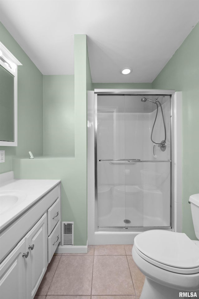 bathroom featuring vanity, toilet, an enclosed shower, and tile patterned flooring