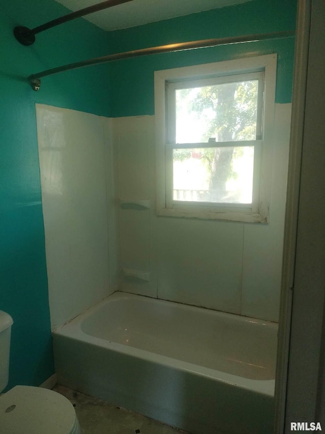 bathroom with tub / shower combination and toilet