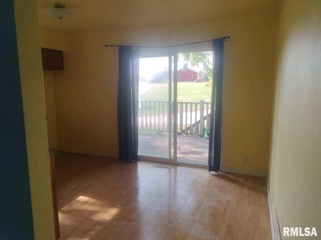 unfurnished room featuring light hardwood / wood-style floors