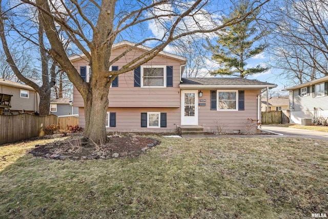 split level home featuring a front lawn