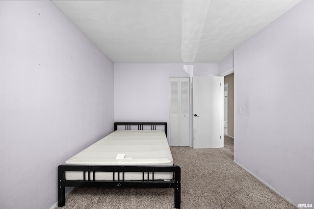 carpeted bedroom featuring a closet