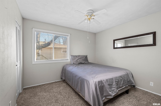 carpeted bedroom with ceiling fan and a closet