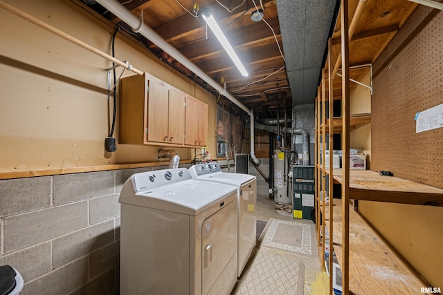 laundry area with cabinets, gas water heater, and washing machine and dryer