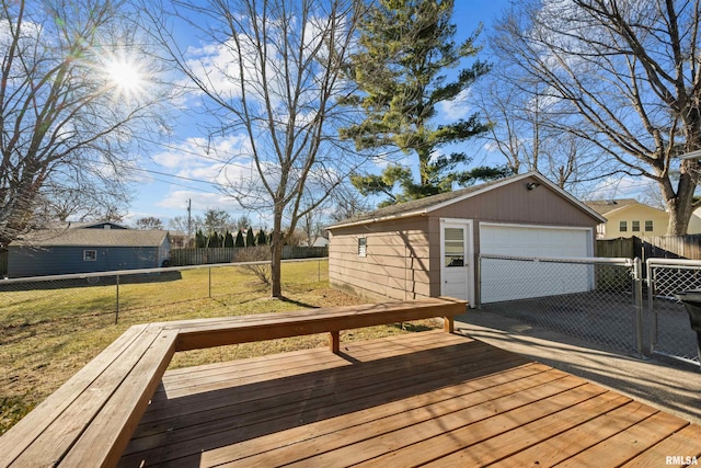 deck featuring a garage, a yard, and an outbuilding