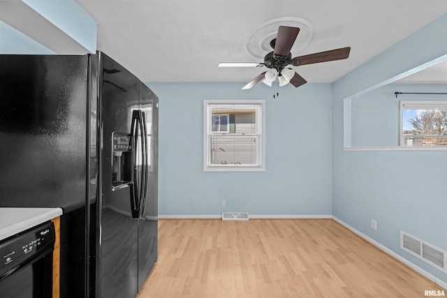 kitchen featuring ceiling fan, light wood-type flooring, and black appliances